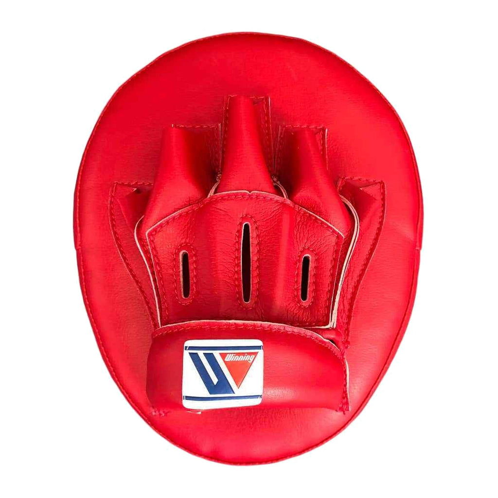 Red curved punch mitt striking face close-up